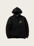 Black hoodie with a logo on the chest against a light beige background