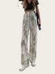 Person wearing tie-dye pants on a white background