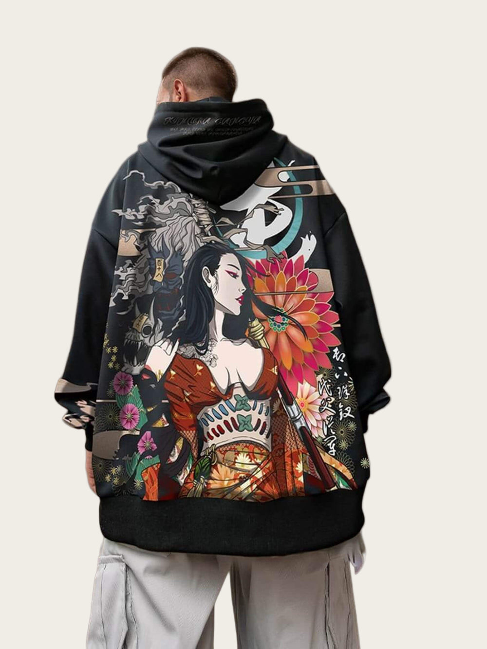 Person wearing a black hoodie with colorful graphic design on the back