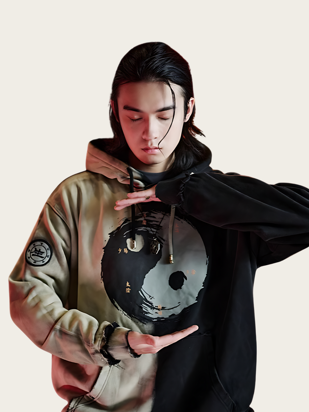 Person wearing a hoodie with a unique design on a plain background