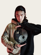 Person wearing a hoodie with a unique design on a plain background
