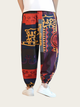 Colorful patterned pants worn by a person on a white background