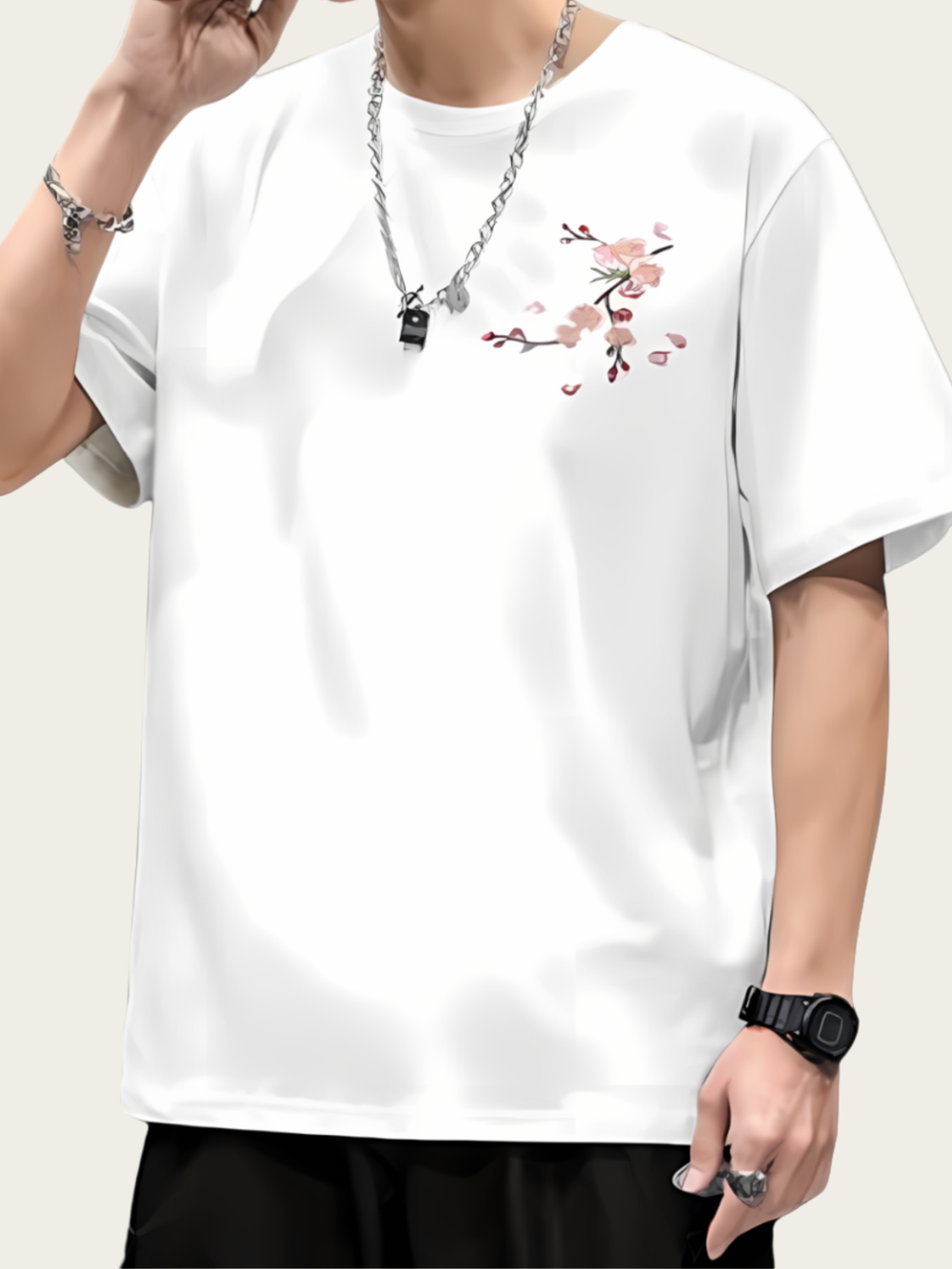 White t-shirt with floral embroidery worn by a person on a plain background
