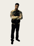 Person wearing a camouflage-patterned varsity jacket on a white background