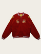 Red jacket with embroidered designs on a beige background