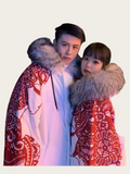 Two people wearing red and white patterned coats with fur hoods against a light background