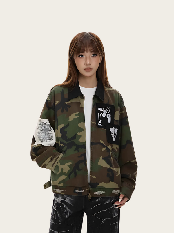 Person wearing a camouflage jacket with unique designs on a plain background