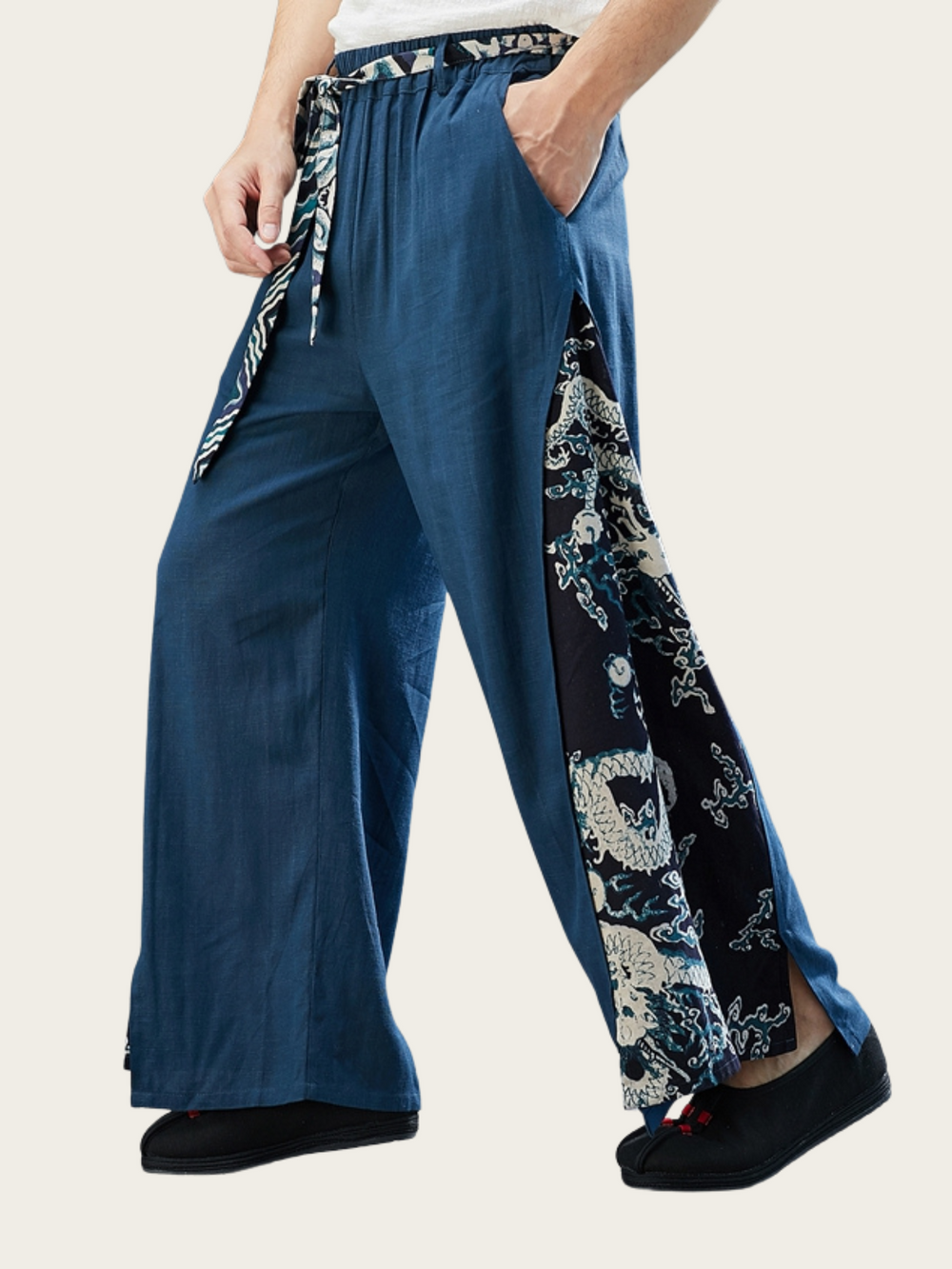Blue wide-leg pants with floral side panels on a plain background
