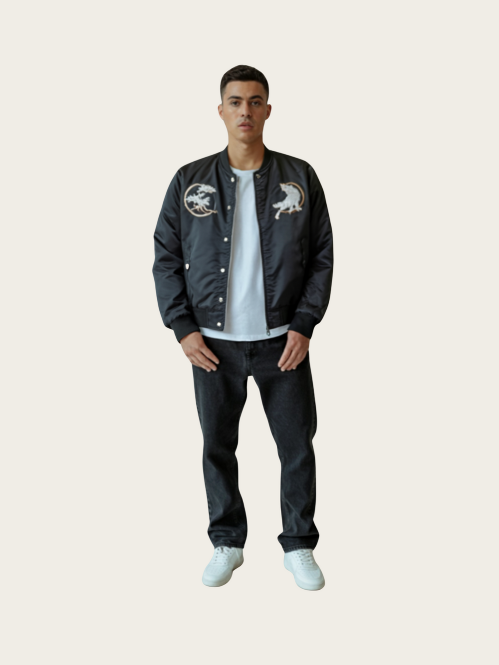 Person wearing a black jacket with white designs on a beige background