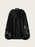 Black hoodie with floral embroidery on a light gray background