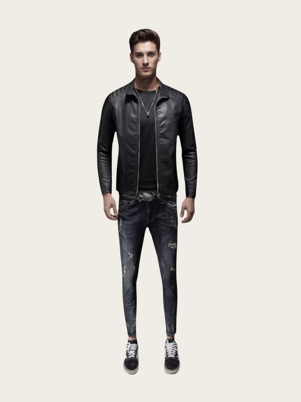 Man wearing a black leather jacket and jeans on a light gray background