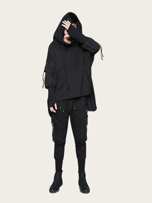Person wearing a black hoodie and pants on a white background