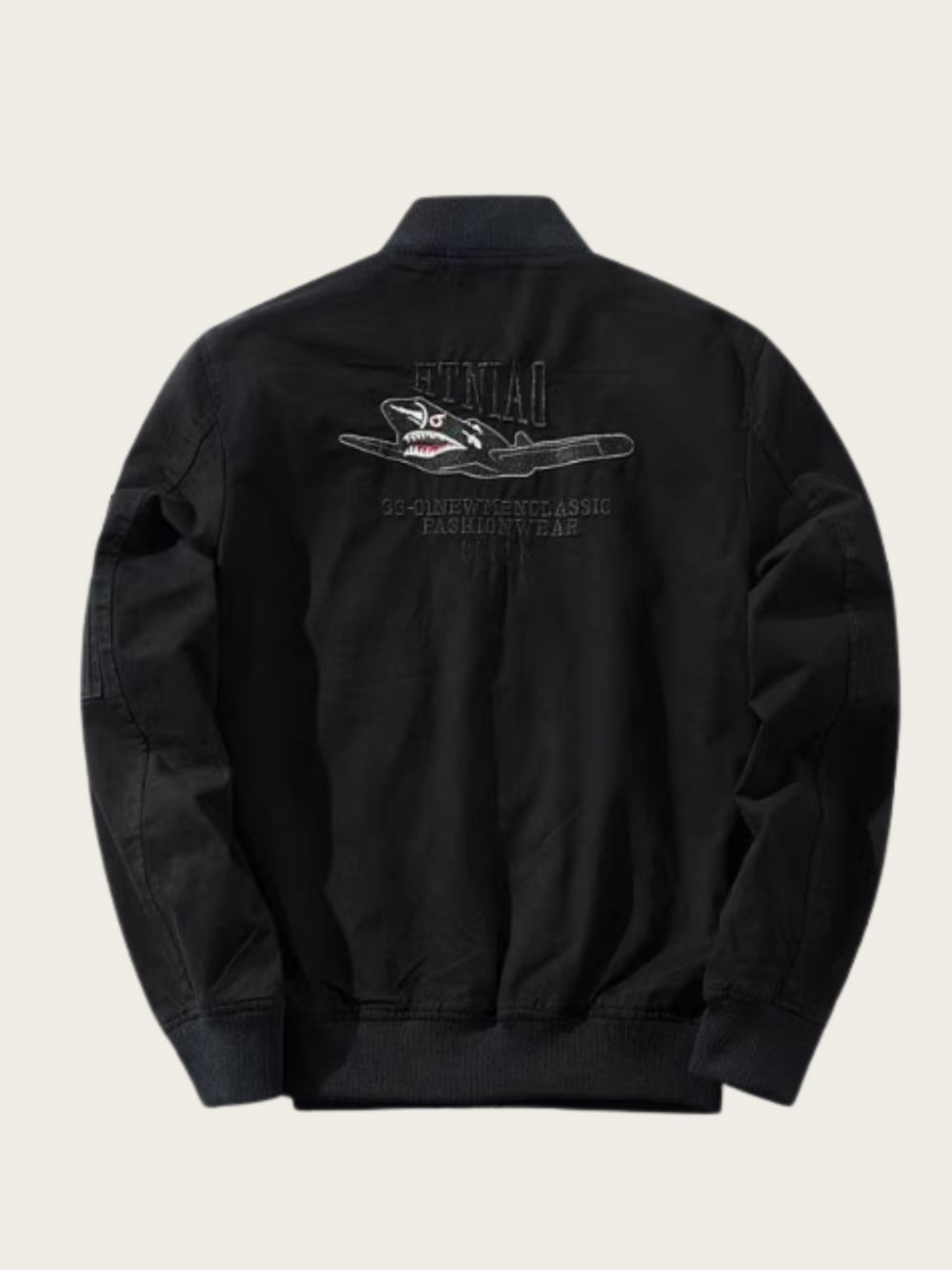 Black jacket with shark graphic and text on the back against a beige background