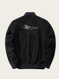 Black jacket with shark graphic and text on the back against a beige background