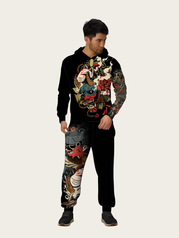 Person wearing a black hoodie and pants with colorful dragon designs on a white background
