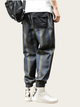 Person wearing plaid pants with a neutral background