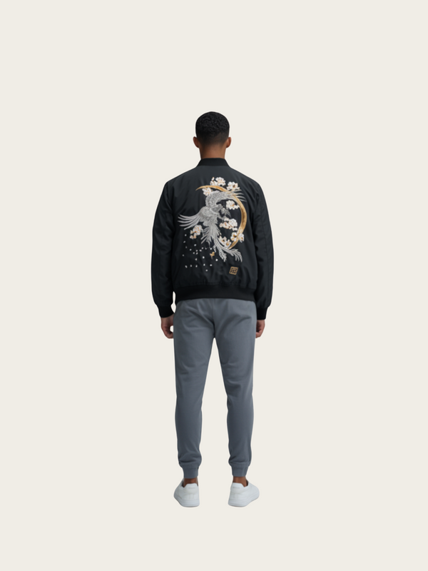Person wearing a black jacket with a design on the back against a white background