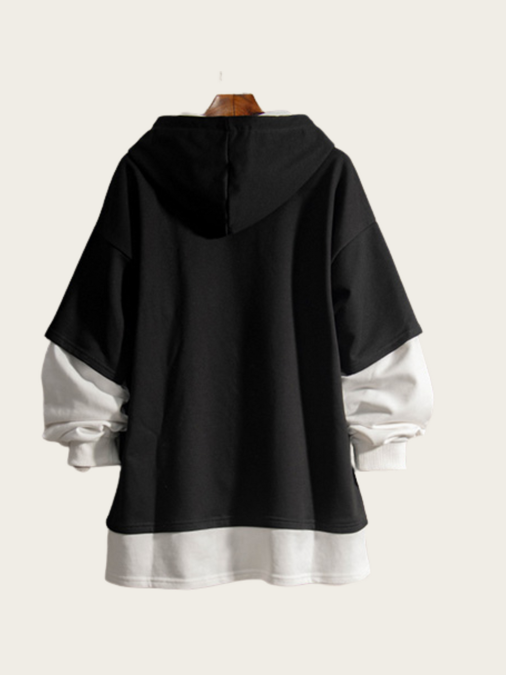 Black and white layered hoodie on a mannequin against a white background