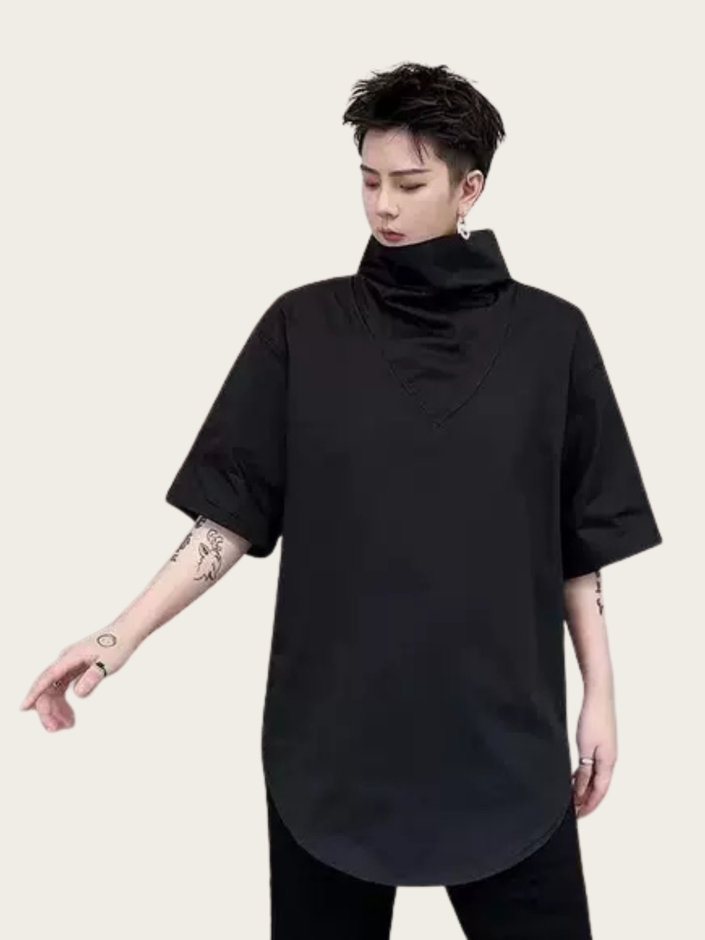 Person wearing a black turtleneck shirt on a beige background