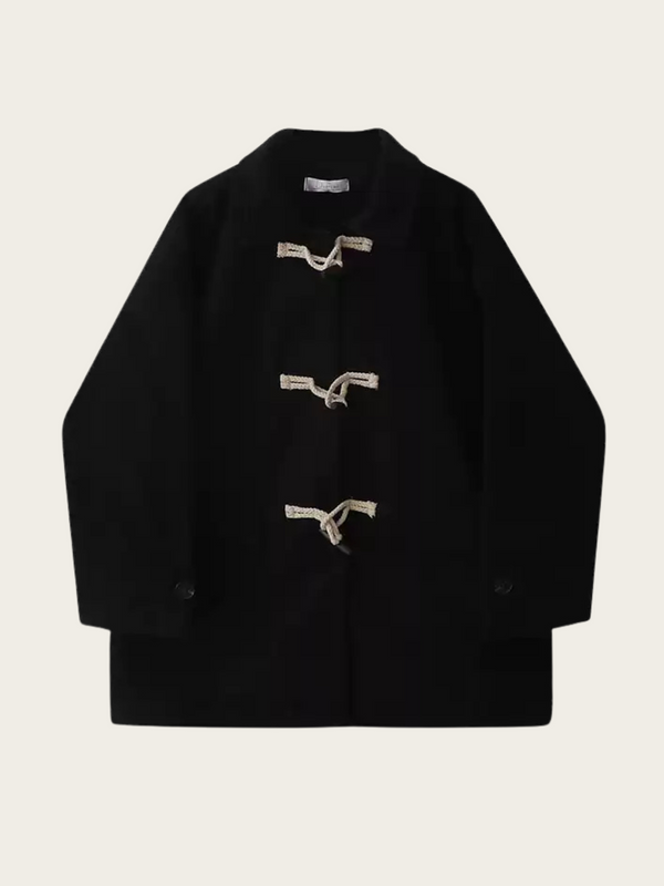 Black coat with button details on a light beige background
