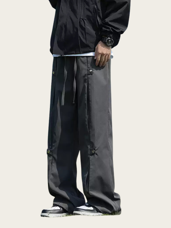 Person wearing black jacket and pants on a white background