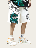 Person wearing a white skirt with cartoon dinosaur design and white sneakers on a light background