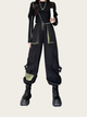 Person wearing a black and green outfit with cargo pants on a white background