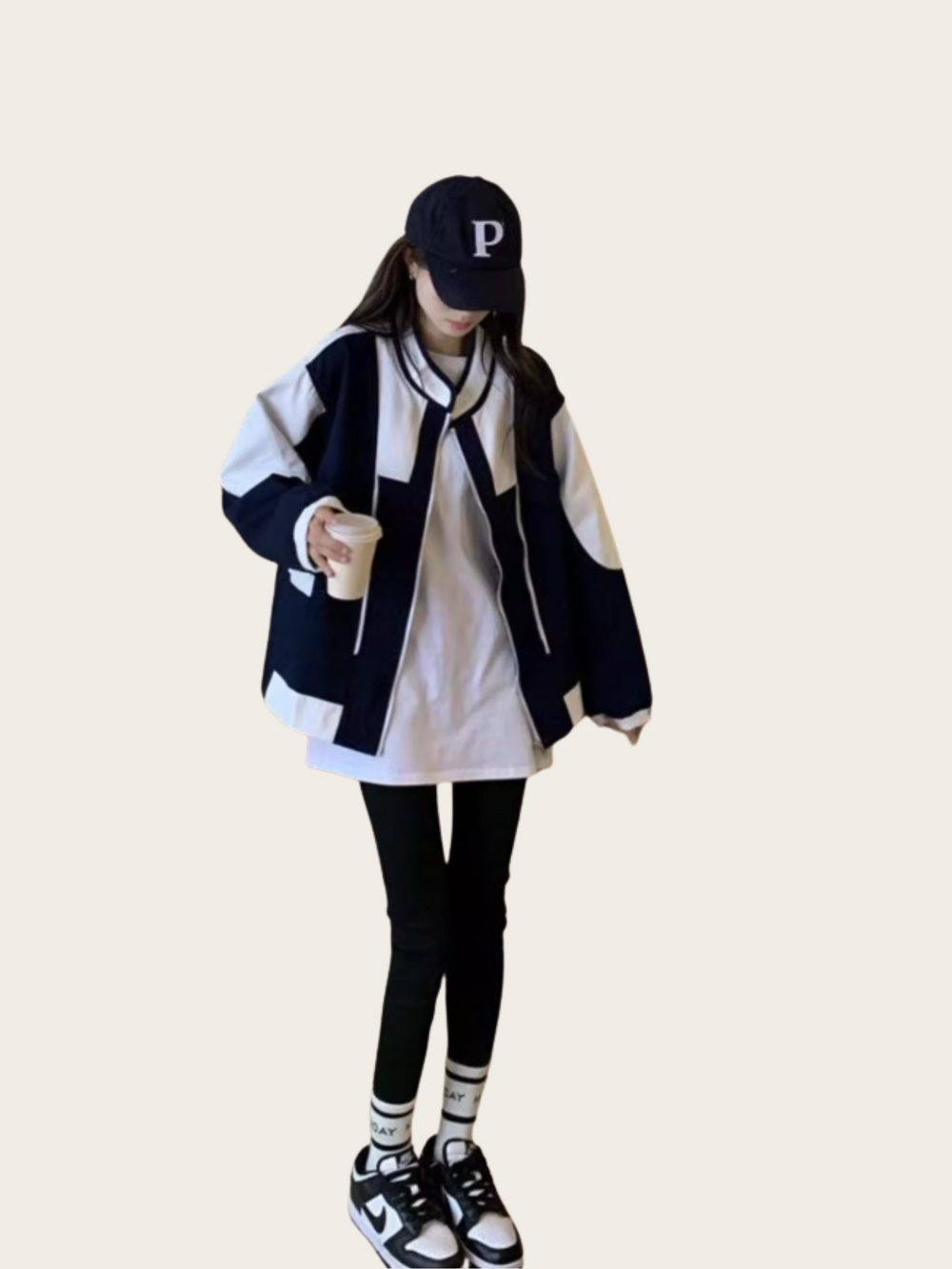 Person wearing a striped jacket, white shirt, black pants, and a cap with a 'P' on a beige background