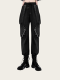 Black cargo pants with suspenders and chains on a white background