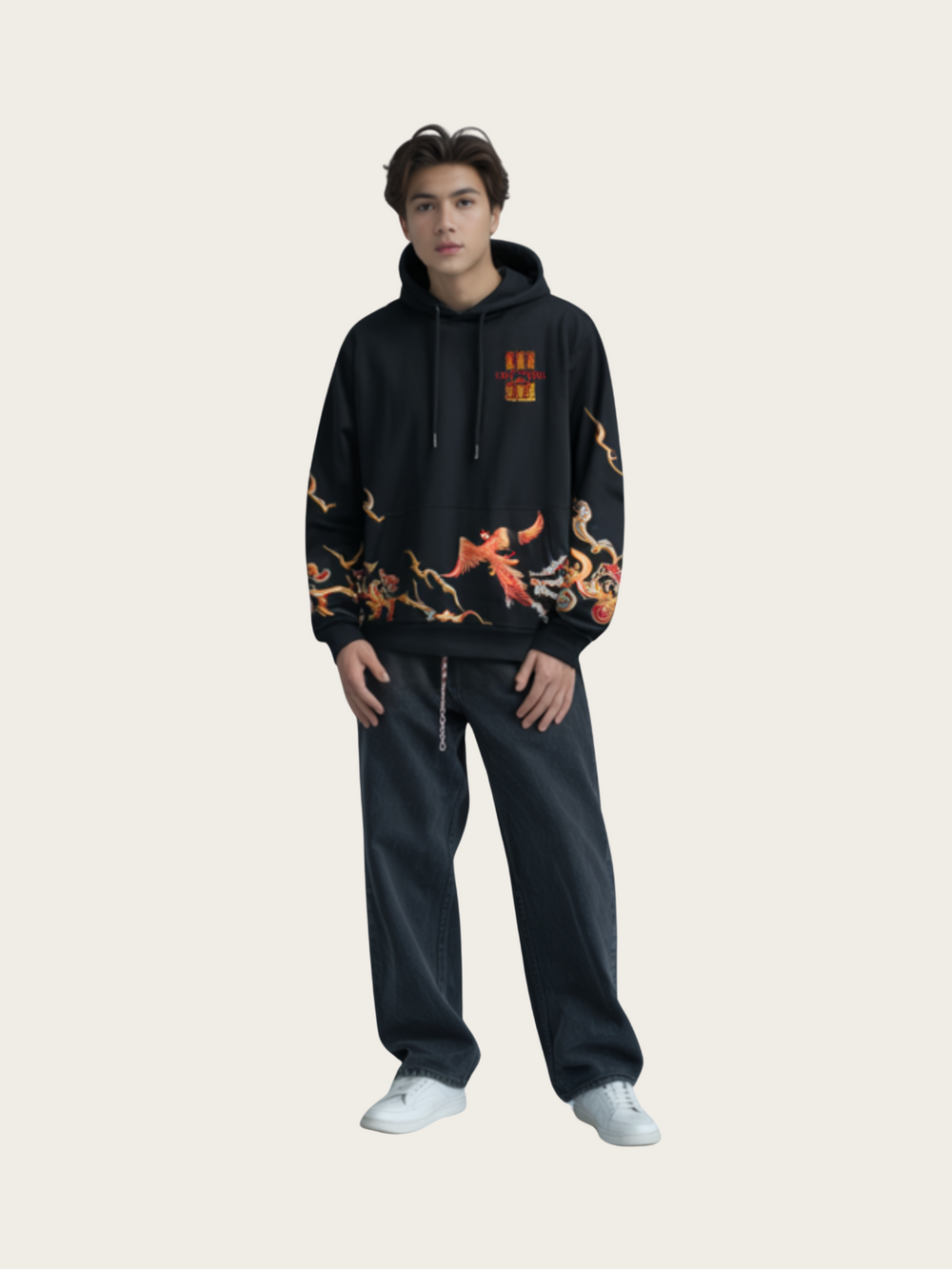 Person wearing a black hoodie with colorful designs and dark pants on a light gray background