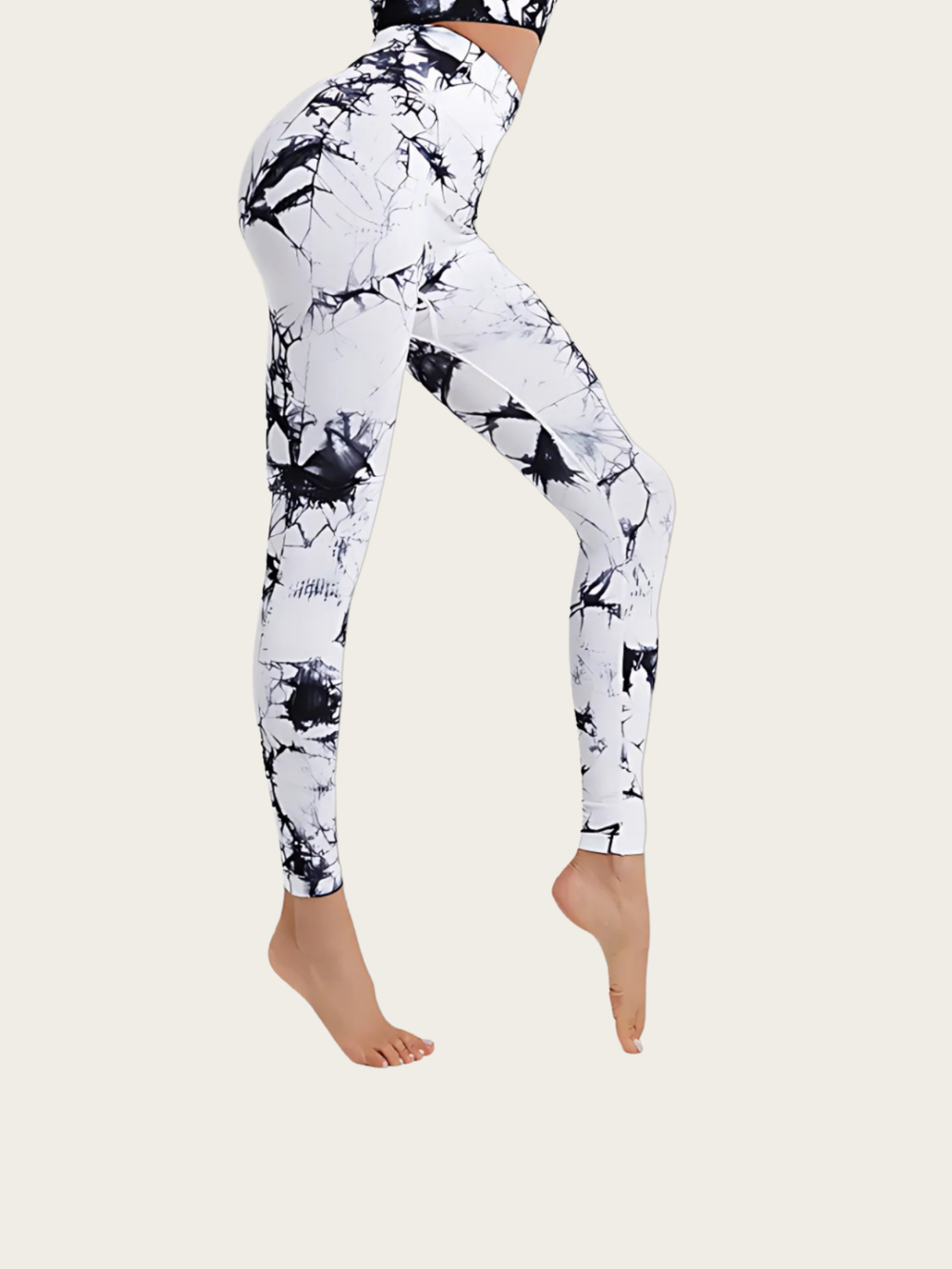 White leggings with black abstract pattern worn by a person on a white background