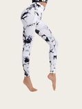White leggings with black abstract pattern worn by a person on a white background