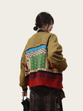 Person wearing a colorful patterned jacket on a plain background