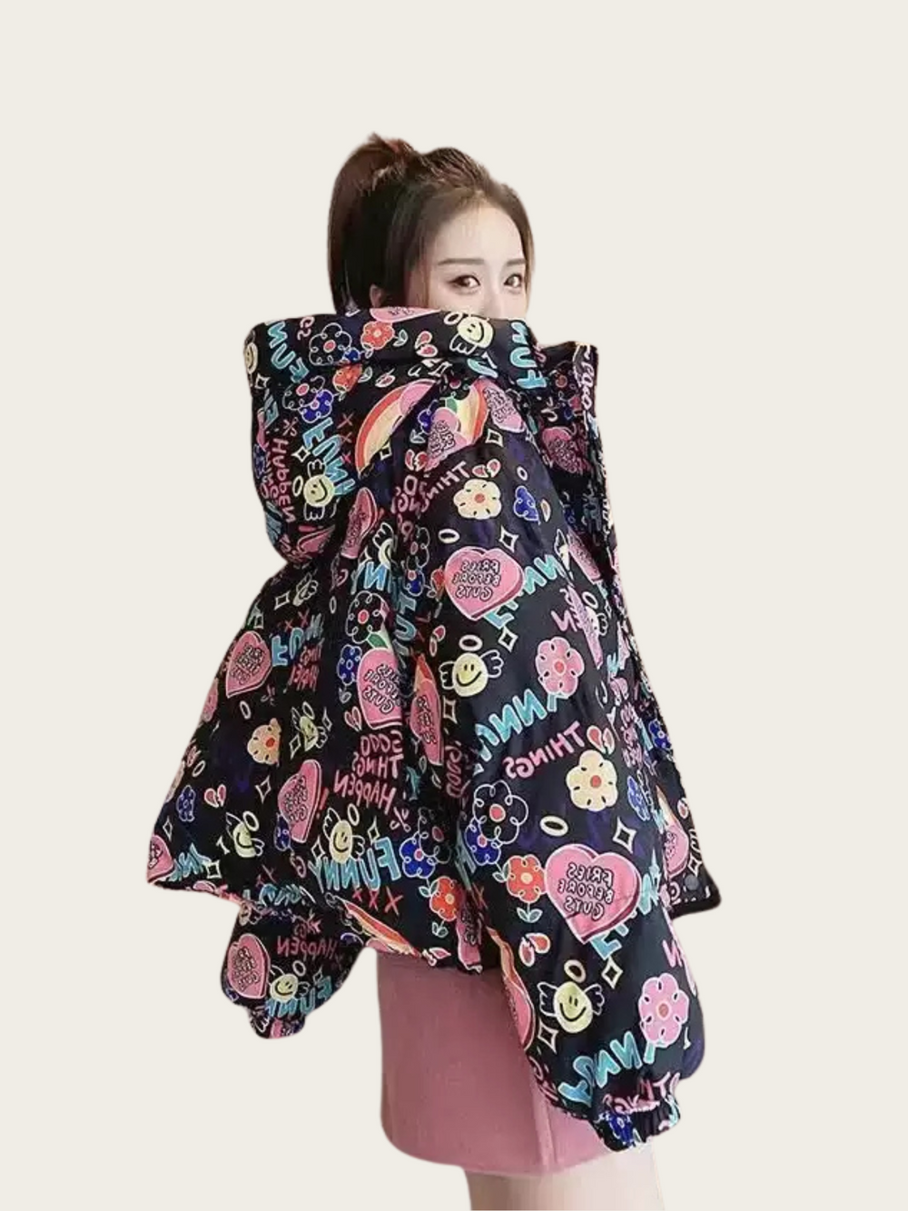 Person wearing a colorful patterned coat with a white background