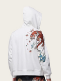 White hoodie with colorful tiger design on the back against a beige background