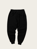 Black pants on a light beige background