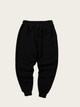 Black pants on a light beige background