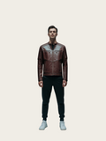 Man wearing a brown leather jacket on a light beige background