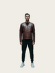 Man wearing a brown leather jacket on a light beige background