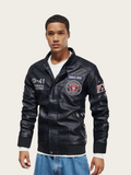 Man wearing a black leather jacket with patches on a beige background