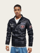 Man wearing a black leather jacket with patches on a beige background