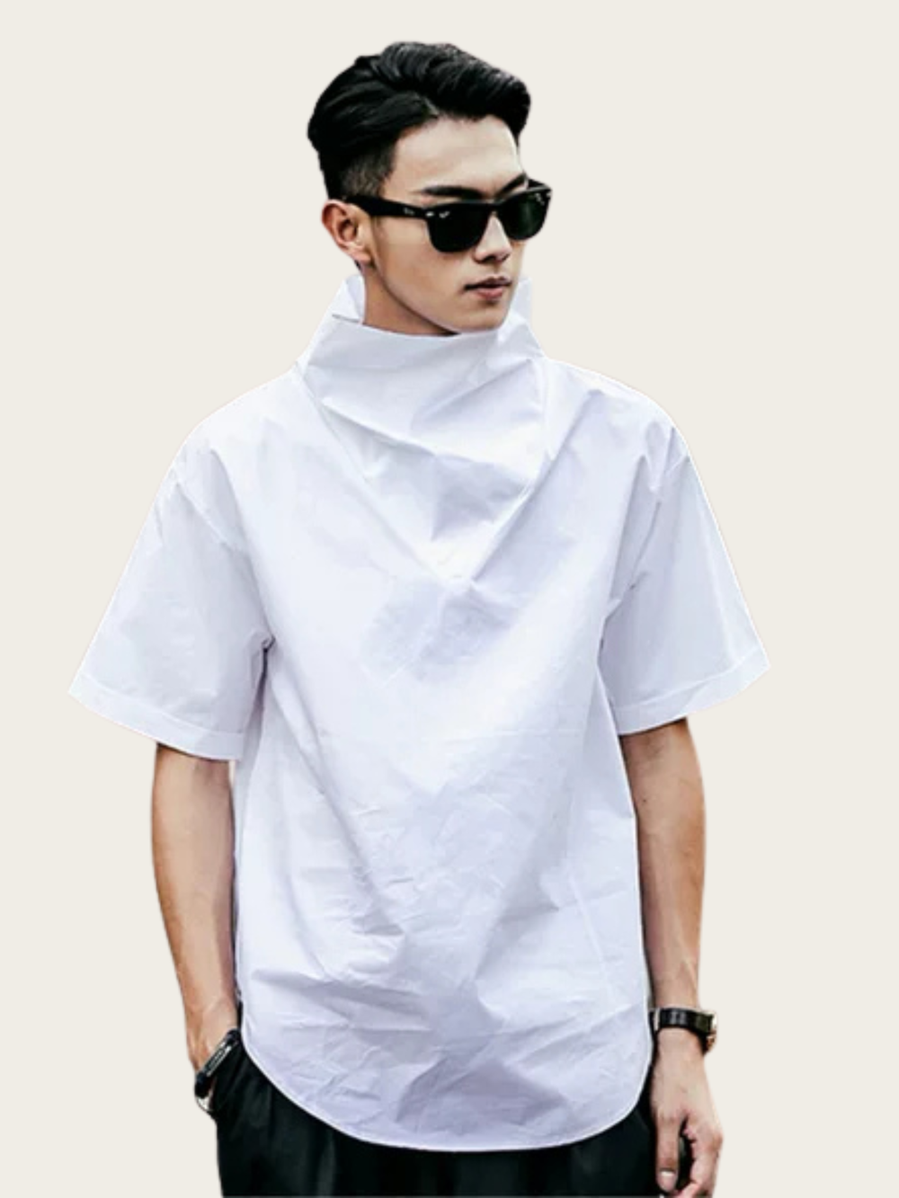 Person wearing a white turtleneck shirt and sunglasses on a plain background