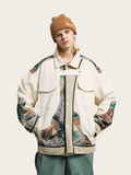 Person wearing a stylish jacket with floral patterns and a brown beanie on a light background