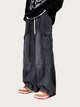 Person wearing black cargo pants with a white background