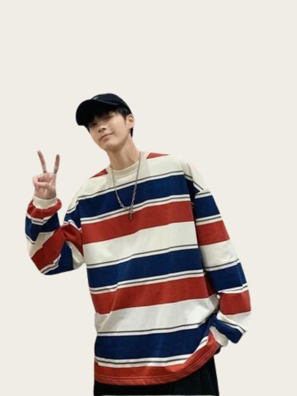 Person wearing a red, white, and blue striped sweater on a plain background