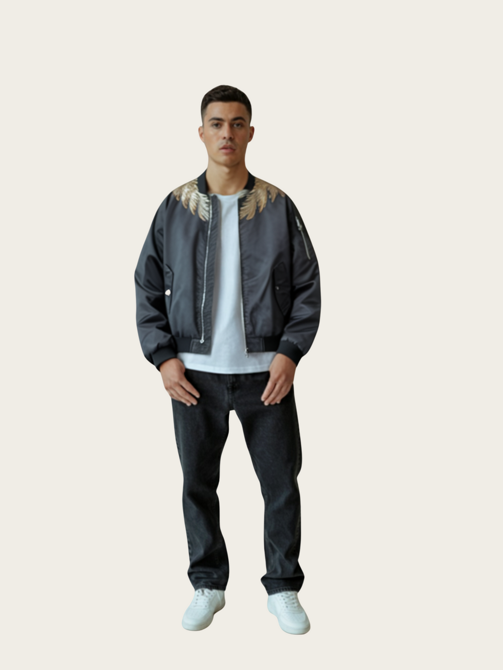 Man wearing a dark jacket with fur trim, white shirt, black pants, and white shoes on a beige background