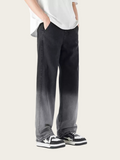 Person wearing black pants and white sneakers on a plain background
