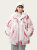 Person wearing a pink and white tie-dye jacket on a plain background