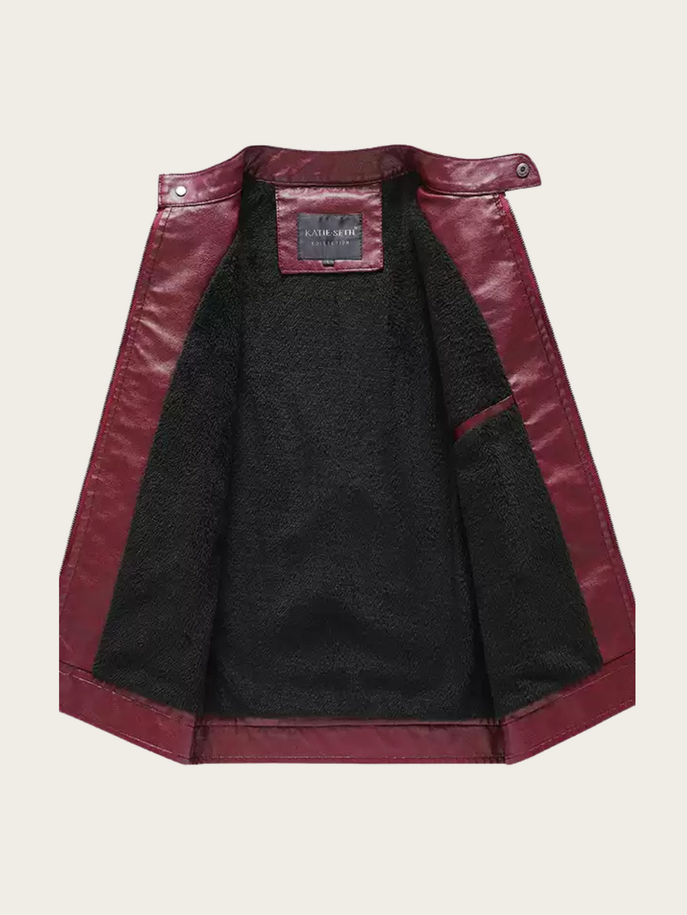 Black jacket with burgundy leather sleeves on a beige background