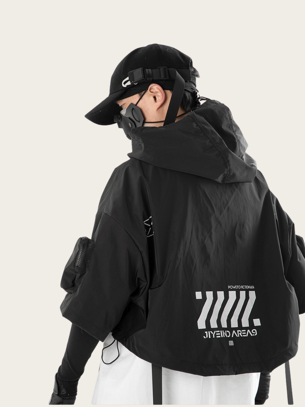 Person wearing a black jacket with a brand logo on a white background